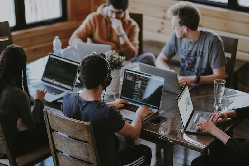 Teams collaborating in a modern workspace, representing the shift to AI-augmented team coordination